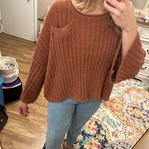 Burnt orange sweater.